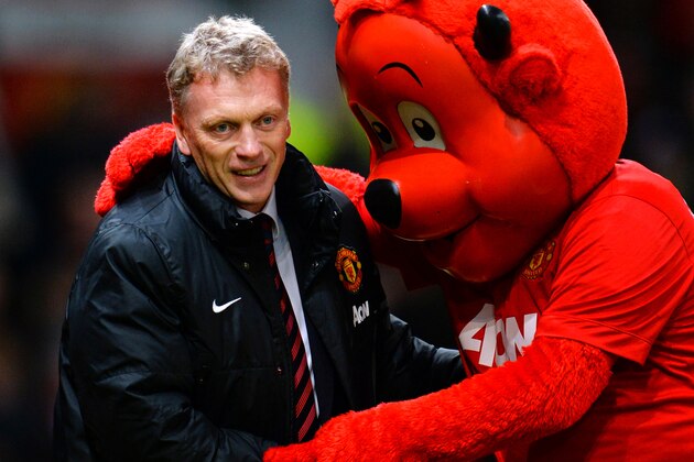 MANCHESTER, ENGLAND - JANUARY 11:  Manchester United Manager David Moyes is greeted by mascot Fred the Red prior to the Barclays Premier League match between Manchester United and Swansea City at Old Trafford on January 11, 2014 in Manchester, England.  (Photo by Shaun Botterill/Getty Images)