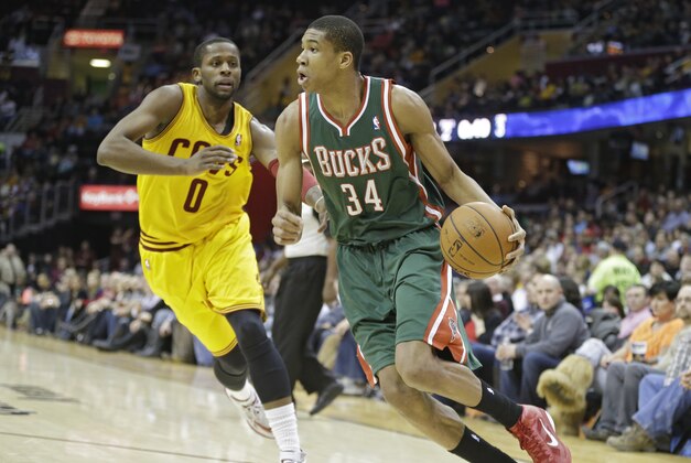 Milwaukee Bucks' Giannis Antetokounmpo (34), from Greece, drives past Cleveland Cavaliers' C.J. Miles (0) in an NBA basketball game Friday, Jan. 24, 2014, in Cleveland. (AP Photo/Mark Duncan)