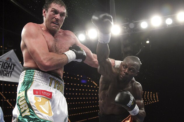 Tyson Fury, left,  Steve Cunningham exchange punches during a heavyweight boxing match on Saturday, April 20, 2013, at the Theatre at Madison Square Garden in New York. Fury knocked out Cunningham in the seventh round. (AP Photo/Mary Altaffer)