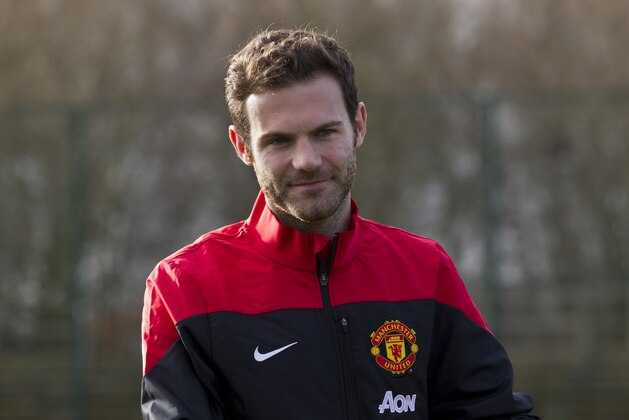 Manchester United's new signing Juan Mata stands before a press conference at the team's Carrington training ground, Manchester, England, Monday, Jan. 27, 2014. With Manchester United in danger of missing out on the Champions League next season, Juan Mata's arrival at Old Trafford for a club record fee of 37.1 million pounds ($61.2 million) is certainly an emergency move. But it also marks the first step in the rebuilding process of England's most titled club. After a botched transfer campaign last summer that was followed by the club's lackluster first half of the season, United now looks determined to allow manager David Moyes the opportunity to build his own team.(AP Photo/Jon Super)