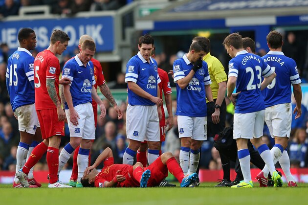 LIVERPOOL, ENGLAND - NOVEMBER 23:  Luis Suarez of Liverpool lies on the pitch after being fouled by Kevin Mirallas of Everton during the Barclays Premier League match between Everton and Liverpool at Goodison Park on November 23, 2013 in Liverpool, England.  (Photo by Alex Livesey/Getty Images)