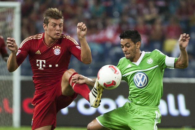 GUANGZHOU, CHINA - JULY 26:  Toni Kroos (L) of Bayern Munich and Josue of VfL Wolfsburg fight for a ball during a friendly match as part of the Audi Football Summit 2012 on July 26, 2012 at the Guangdong Olympic Sports Center in Guangzhou, China.  (Photo by Victor Fraile/Getty Images)