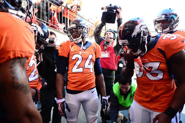 Jan 12, 2014; Denver, CO, USA; Members of the Denver Broncos huddle with cornerback Champ Bailey (24) before the game against the San Diego Chargers during the 2013 AFC divisional playoff football game at Sports Authority Field at Mile High. Mandatory Credit: Ron Chenoy-USA TODAY Sports