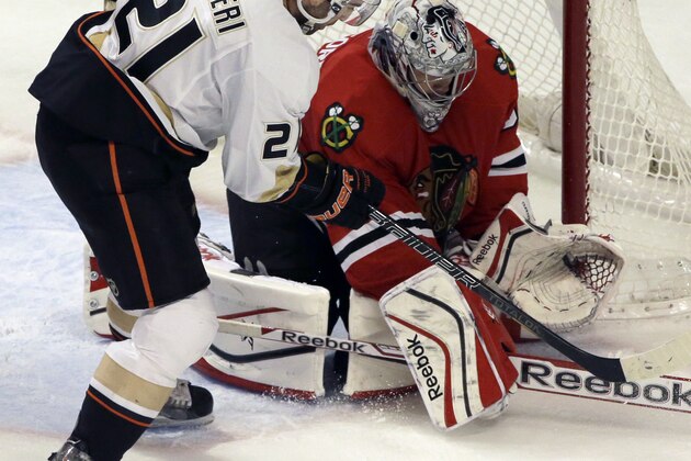 Chicago Blackhawks goalie Corey Crawford (50) blocks a shot by Anaheim Ducks' Kyle Palmieri (21) during the third period of an NHL hockey game in Chicago, Friday, Jan. 17, 2014. The Blackhawks won 4-2. (AP Photo/Nam Y. Huh)