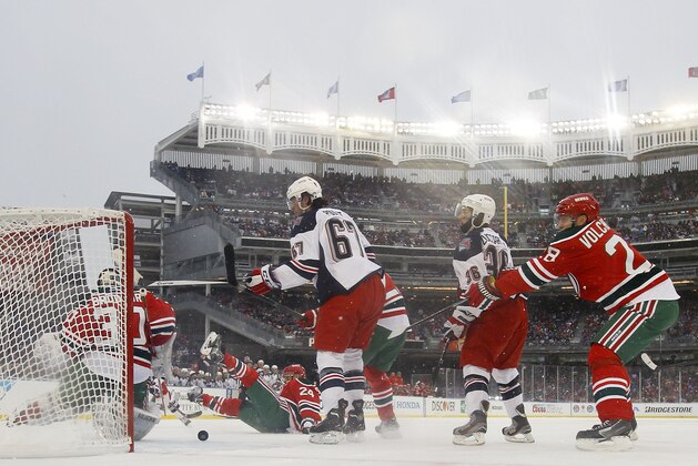 NEW YORK, NY - JANUARY 26:  (EDITORIAL USE ONLY) Martin Brodeur #30 of the New Jersey Devils defends against Benoit Pouliot #67 of the New York Rangers during the 2014 Coors Light NHL Stadium Series at Yankee Stadium on January 26, 2014 in the Bronx borough of New York City.  (Photo by Bruce Bennett/Getty Images)