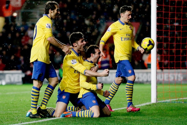 Arsenal's Santi Cazorla, third right, celebrates his goal with, from left, Mathieu Flamini, Olivier Giroud and Mesut Ozil during the English Premier League soccer match between Southampton and Arsenal at St Mary's stadium in Southampton, Tuesday, Jan. 28, 2014.  (AP Photo/Matt Dunham)