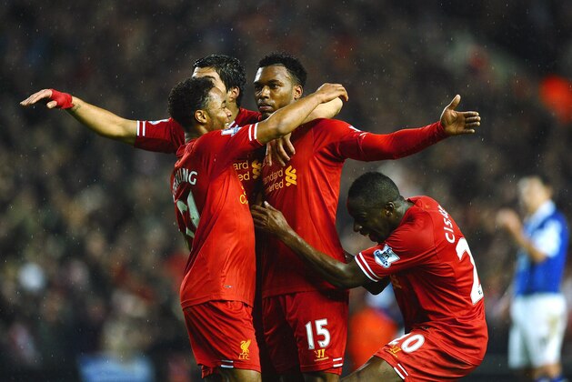 LIVERPOOL, ENGLAND - JANUARY 28:  Daniel Sturridge (C) of Liverpool is congratulated by teammates Luis Suarez (2nd L), Raheem Sterling (L) and  after scoring his team's third goal Aly Cissokho during the Barclays Premier League match between Liverpool and Everton at Anfield on January 28, 2014 in Liverpool, England.  (Photo by Laurence Griffiths/Getty Images)