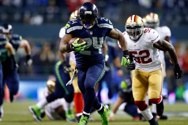 SEATTLE, WA - JANUARY 19:  Running back Marshawn Lynch #24 of the Seattle Seahawks carries the ball against the San Francisco 49ers during the 2014 NFC Championship at CenturyLink Field on January 19, 2014 in Seattle, Washington.  (Photo by Jonathan Ferrey/Getty Images)