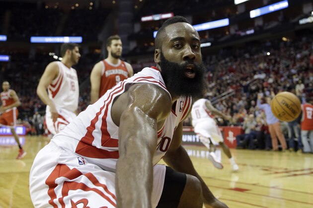 Houston Rockets' James Harden strikes a pose after dunking the ball against the Milwaukee Bucks during the third quarter of an NBA basketball game Saturday, Jan. 18, 2014, in Houston. The Rockets won114-104. (AP Photo/David J. Phillip)