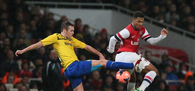 Arsenal's Serge Gnabry, right, challenges for the ball with Coventry's Blair Adams during their 4th round English FA Cup soccer match between Arsenal and Coventry City at the Emirates stadium in London, Friday, Jan.  24, 2014. (AP Photo/Alastair Grant)