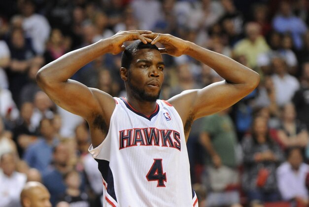 Dec 23, 2013; Miami, FL, USA; Atlanta Hawks power forward Paul Millsap (4) reacts after fouling out during the second half against the Miami Heat at American Airlines Arena. The Heat won 121-119 in overtime. Mandatory Credit: Steve Mitchell-USA TODAY Sports
