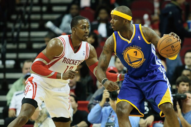 HOUSTON, TX - DECEMBER 06:  Jermaine O'Neal #7 of the Golden State Warriors drives against Dwight Howard #12 of the Houston Rockets during the game at Toyota Center on December 6, 2013 in Houston, Texas. NOTE TO USER: User expressly acknowledges and agrees that, by downloading and or using this photograph, User is consenting to the terms and conditions of the Getty Images License Agreement.  (Photo by Scott Halleran/Getty Images)