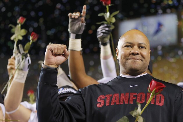 Stanford head coach David Shaw holds a rose after the NCAA Pac-12 Championship football game, Saturday, Dec. 7, 2013, in Tempe, Ariz. Stanford defeated Arizona State 38-14.(AP Photo/Matt York)