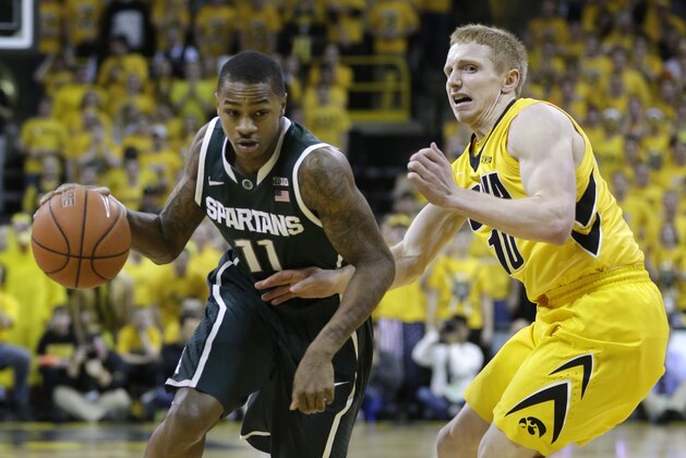Michigan State guard Keith Appling, left, drives past Iowa guard Mike Gesell during the first half of an NCAA college basketball game, Tuesday, Jan. 28, 2014, in Iowa City, Iowa. (AP Photo/Charlie Neibergall)
