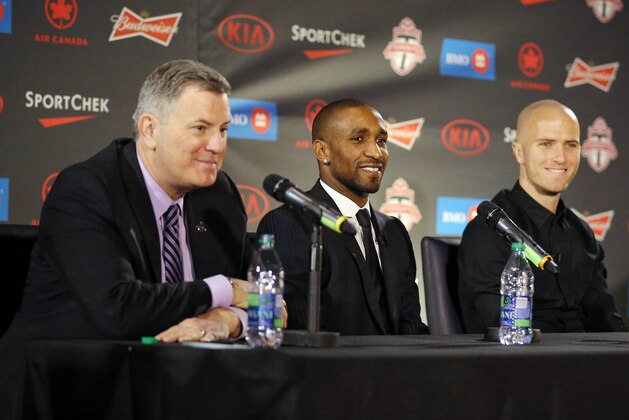 Jan 13, 2014; Toronto, Ontario, Canada; Toronto FC new player Jermain Defoe (middle) and Michael Bradley (right) and CEO of MLSE Tim Leiweke during a press conference at Real Sports Bar and Grill. Mandatory Credit: Tom Szczerbowski-USA TODAY Sports