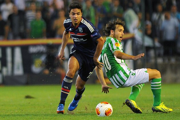 SEVILLE, SPAIN - SEPTEMBER 19:  Clement Grenier (L) of Olympique Lyonnais is challenged by Joan Verdu of Real Betis Balompie during the UEFA Europa League group stage match between Real Betis Balompie and Olympique Lyonnais held on September 19, 2013 at the Benito Villamarin Stadium, in Seville, Spain. (Photo by Jorge Guerrero/EuroFootball/Getty Images)