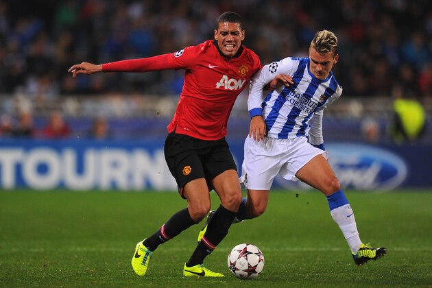 SAN SEBASTIAN, SPAIN - NOVEMBER 05:  Chris Smalling of Manchester United battles with Antoine Griezmann of Real Sociedad during the UEFA Champions League Group A match between Real Sociedad and Manchester United at Estadio Anoeta on November 5, 2013 in San Sebastian, Spain.  (Photo by Mike Hewitt/Getty Images)