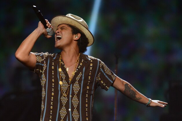 FILE - In this Sept. 21, 2013 file photo, Bruno Mars performs at IHeartRadio Music Festival in Las Vegas. Billboard announced Friday, Dec. 13, 2013, that the pop crooner is the year’s top overall artist. Mars' year included a No. 1 hit with “When I Was Your Man” and a top 5 hit with “Treasure.” (Photo by Al Powers/Powers Imagery/Invision /AP, File)