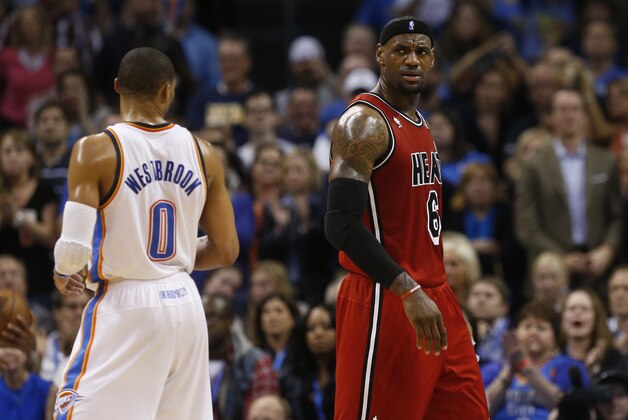 Miami Heat forward LeBron James reacts to a foul call  in front of Oklahoma City Thunder guard Russell Westbrook (0) in the second quarter of an NBA basketball game against the Oklahoma City Thunder in Oklahoma City, Thursday, Feb. 14, 2013. (AP Photo/Sue Ogrocki)