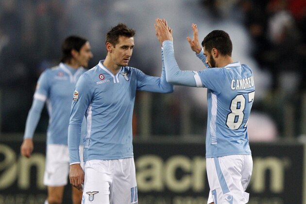 Lazio midfielder Antonio Candreva, right, celebrates woith teammate Miroslav Klose, of Germany, after scoring on a penalty kick during a Serie A soccer match between Lazio and Juventus, at Rome's Olympic stadium, Saturday, Jan. 25, 2014. (AP Photo/Riccardo De Luca)