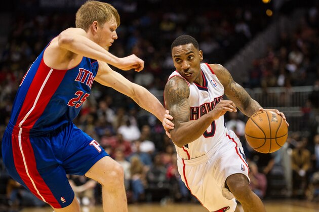 Nov 20, 2013; Atlanta, GA, USA; Atlanta Hawks guard Jeff Teague (0) is defended by Detroit Pistons forward Kyle Singler (25) during the third quarter at Philips Arena. The Hawks won 93-85. Mandatory Credit: Kevin Liles-USA TODAY Sports