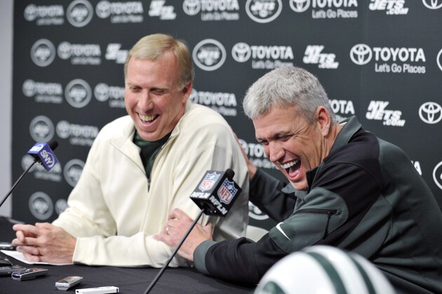 New York Jets coach Rex Ryan, right, and general manager John Idzik react as they speak to the media  during an NFL football news conference Tuesday, Dec. 31, 2013, in Florham Park, N.J. (AP Photo/Bill Kostroun)