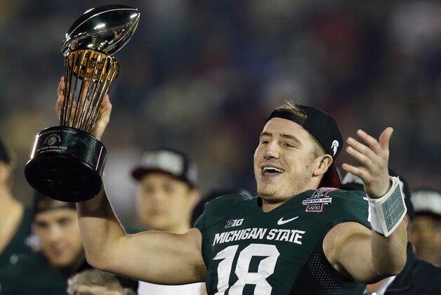 Michigan State quarterback Connor Cook holds the trophy after Michigan State defeated Stanford 24-20 in the Rose Bowl NCAA college football game Wednesday, Jan. 1, 2014, in Pasadena, Calif.  (AP Photo/Danny Moloshok)