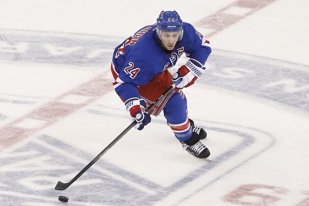 New York Rangers' Ryan Callahan (24) advances the puck against the Dallas Stars during the third period of an NHL hockey game Friday, Jan. 10, 2014, in New York.  New York won 3-2. (AP Photo/Jason DeCrow)