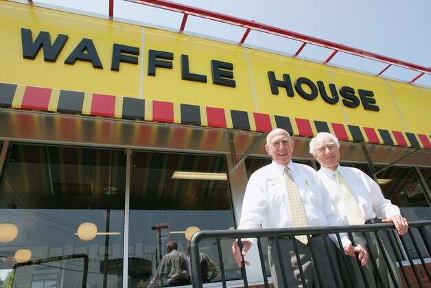 Waffle House founders Joe Rogers, left, and Tom Forkner, right, pose in front of a Waffle House restaurant after eating lunch at the establishment in Norcross, Ga., Tuesday, July 26, 2005. The two founded the eatery in 1955 and have been serving customers the same basic food staples ever since. (AP Photo/Ric Feld)