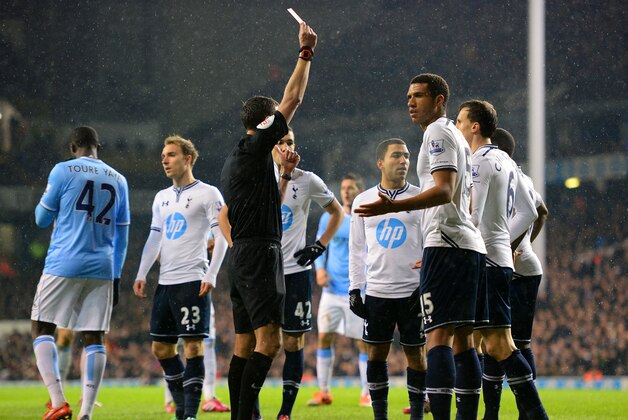 LONDON, ENGLAND - JANUARY 29:  Etienne Capoue of Tottenham Hotspur (R)  looks to Referee Andre Marriner as he shows Danny Rose of Tottenham Hotspur (obstructed) a red card for a foul on Edin Dzeko of Manchester City in the area during the Barclays Premier League match between Tottenham Hotspur and Manchester City at White Hart Lane on January 29, 2014 in London, England.  (Photo by Jamie McDonald/Getty Images)