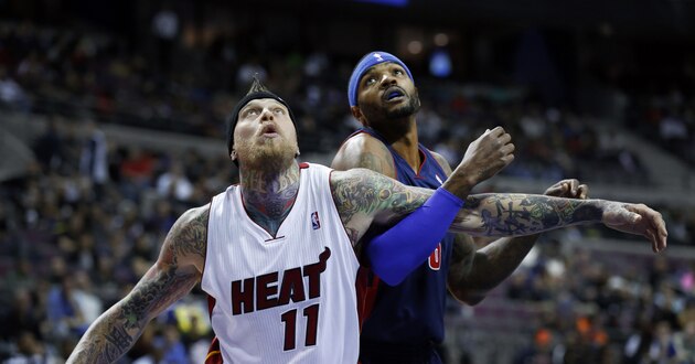 Miami Heat power forward Chris Andersen (11) and Detroit Pistons small forward Josh Smith (6) battle for a rebound in the first quarter of an NBA basketball game in Auburn Hills, Mich., Sunday, Dec. 8, 2013.  (AP Photo/Paul Sancya)