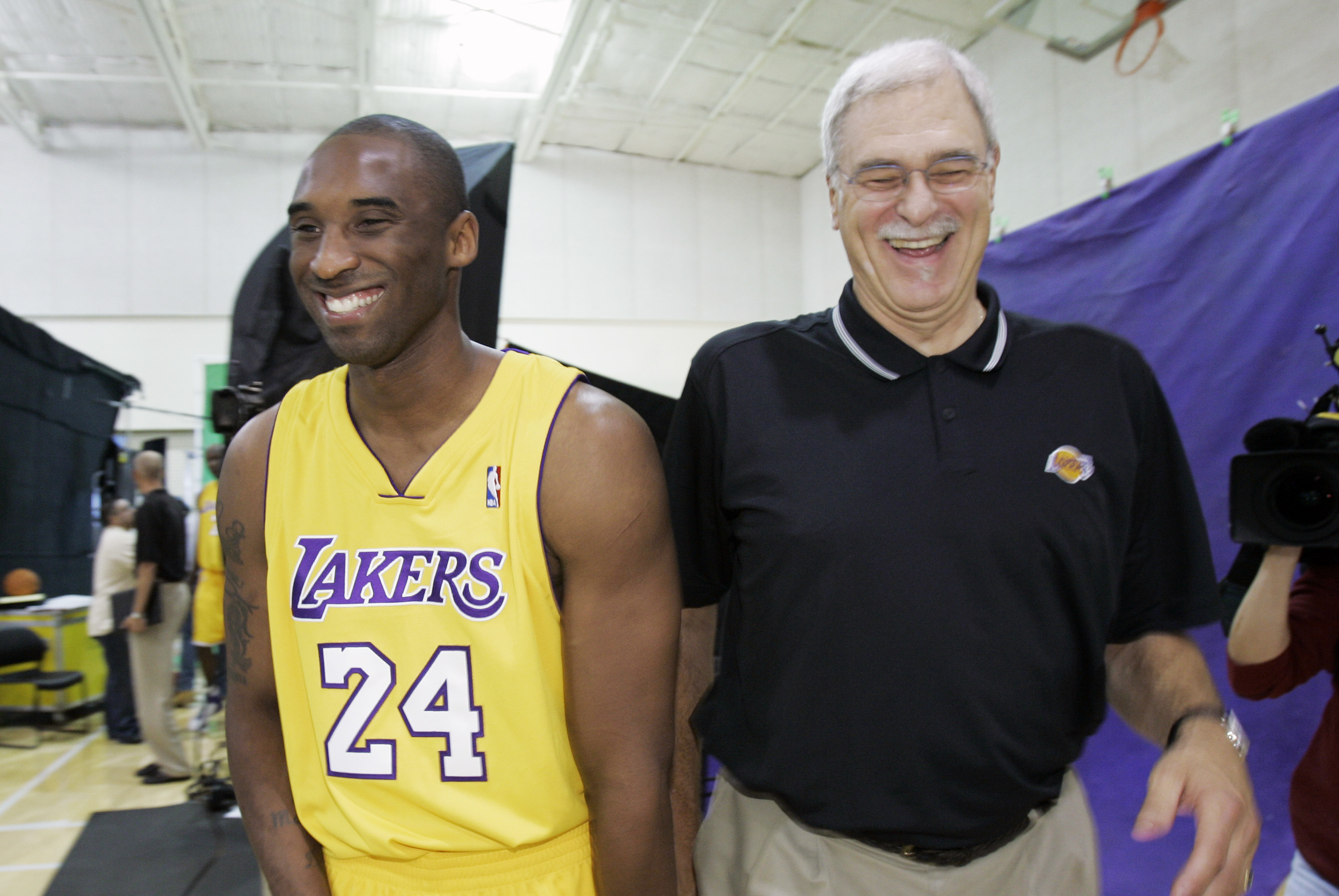 **FILE** Los Angeles Lakers' Kobe Bryant, right, and head coach Phil Jackson share a laugh as they walk to a photo shoot during Lakers media day in El Segundo, Calif., in this file photo from  Oct. 2, 2006. Bryant says he can handle just about any kind of criticism. Calling him a dirty player crosses the line. Bryant reacted angrily to such a concept Wednesday, March 14, 2007, and expressed gratitude for the support given him by Los Angeles Lakers coach Phil Jackson. (AP Photo/Kevork Djansezian-File)
