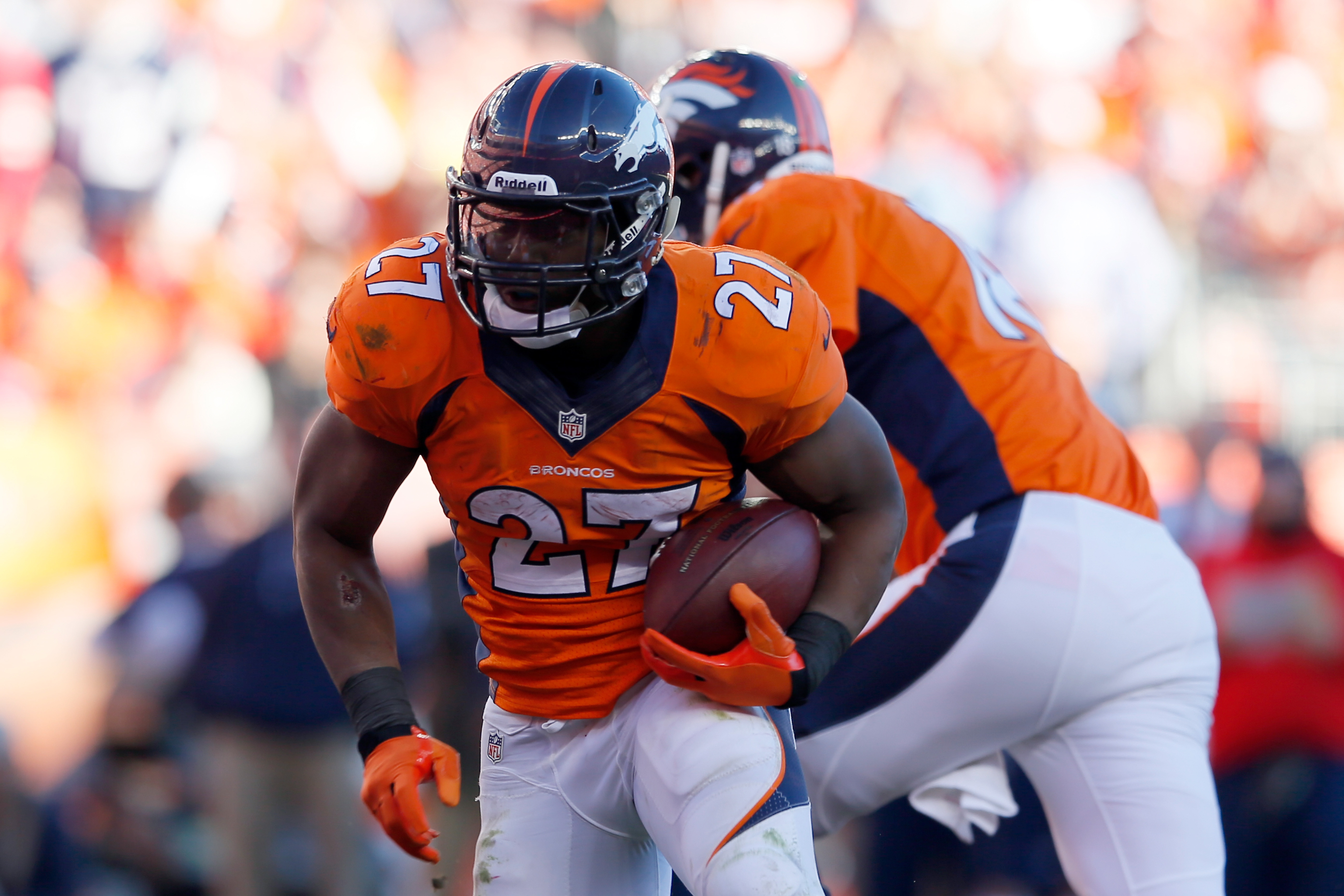 DENVER, CO - JANUARY 19:   Knowshon Moreno #27 of the Denver Broncos runs with the ball against the New England Patriotsduring the AFC Championship game at Sports Authority Field at Mile High on January 19, 2014 in Denver, Colorado.  (Photo by Kevin C. Cox/Getty Images)