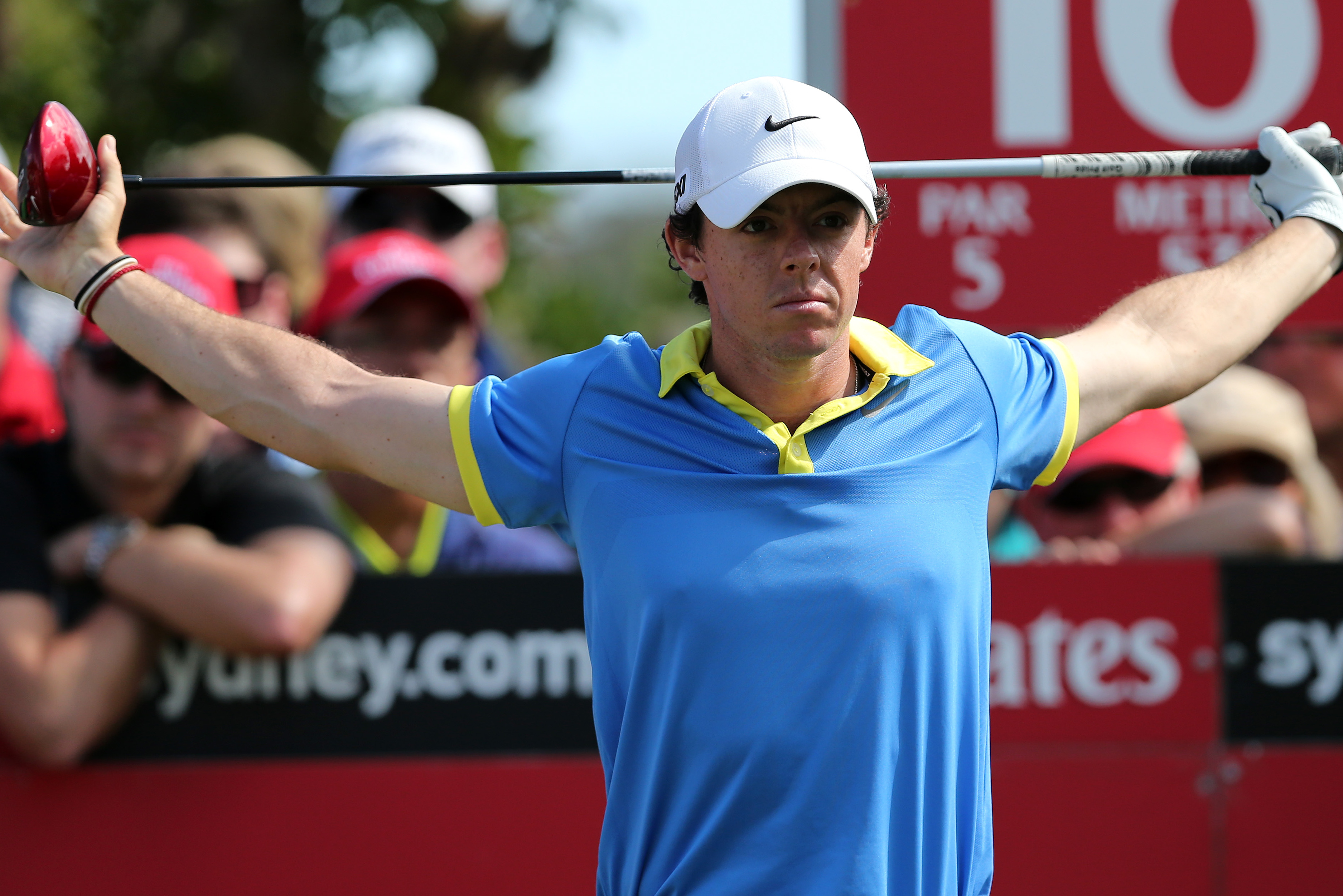Rory McIlroy of Northern Ireland stretches before his tee shot on the 16th hole during his third round of the Australian Open Golf tournament in Sydney, Australia, Saturday, Nov. 30, 2013.(AP Photo/Rob Griffith)