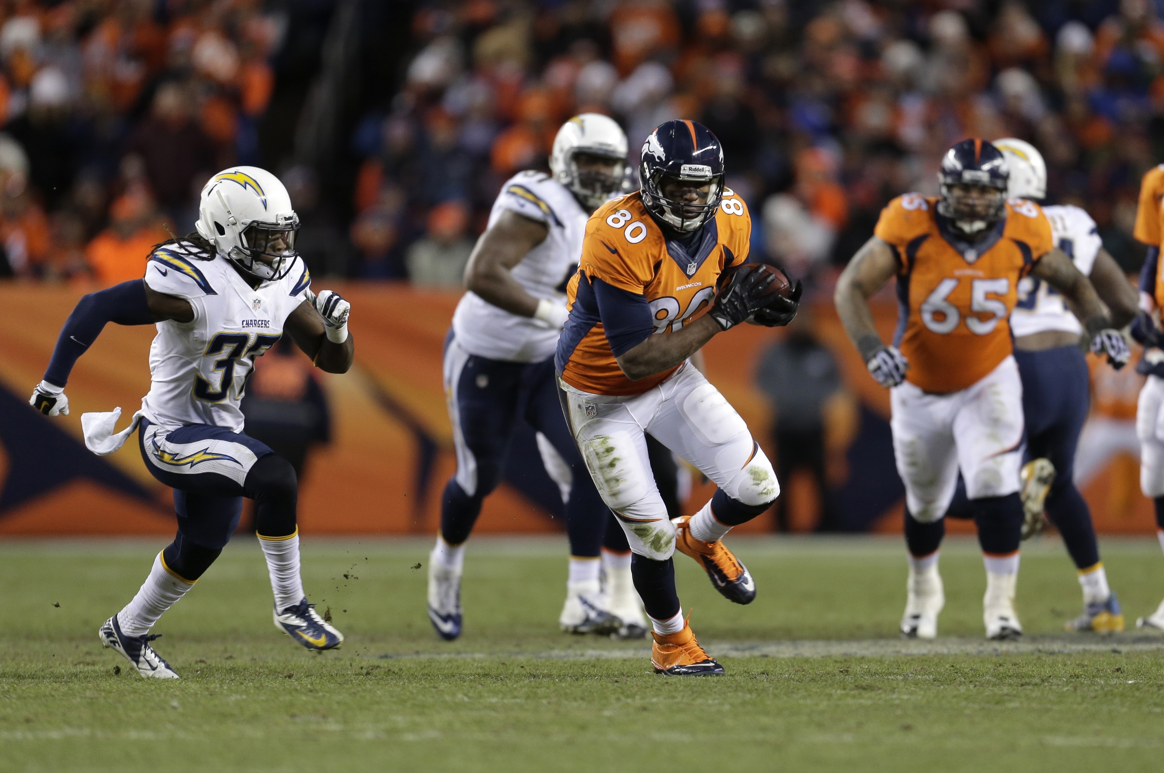 Denver Broncos tight end Julius Thomas (80) carries the ball upfield against the San Diego Chargers in the fourth quarter of an NFL AFC division playoff football game, Sunday, Jan. 12, 2014, in Denver. (AP Photo/Joe Mahoney)