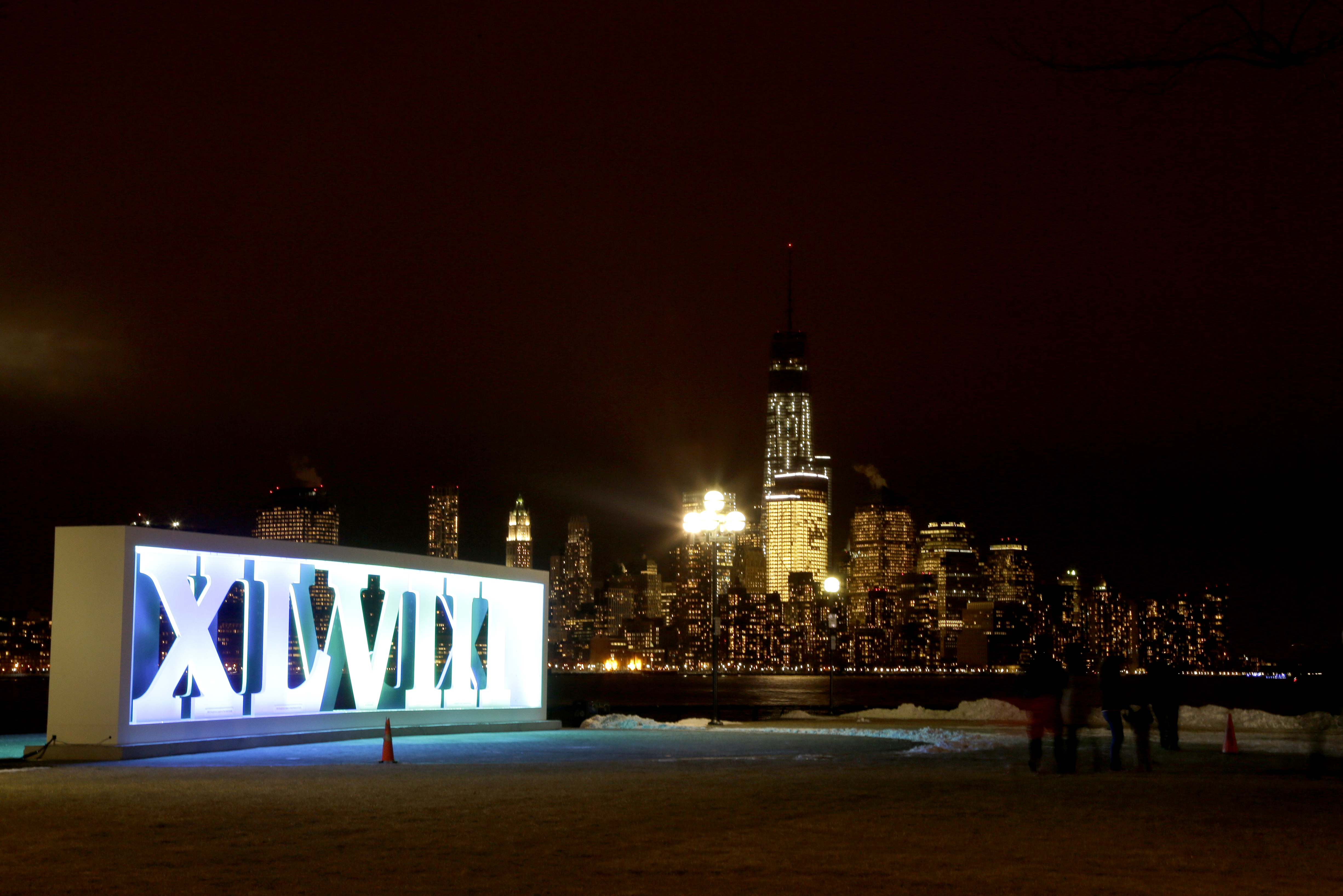 One World Trade Center, top right, gives a backdrop to roman numerals for NFL Super Bowl XLVIII football game standing at Pier A Park in Hoboken, N.J., Tuesday, Jan. 28, 2014. The Seattle Seahawks and the Denver Broncos are scheduled to play on Sunday, Feb. 2, 2014, at MetLife Stadium in East Rutherford, N.J. (AP Photo/Julio Cortez)