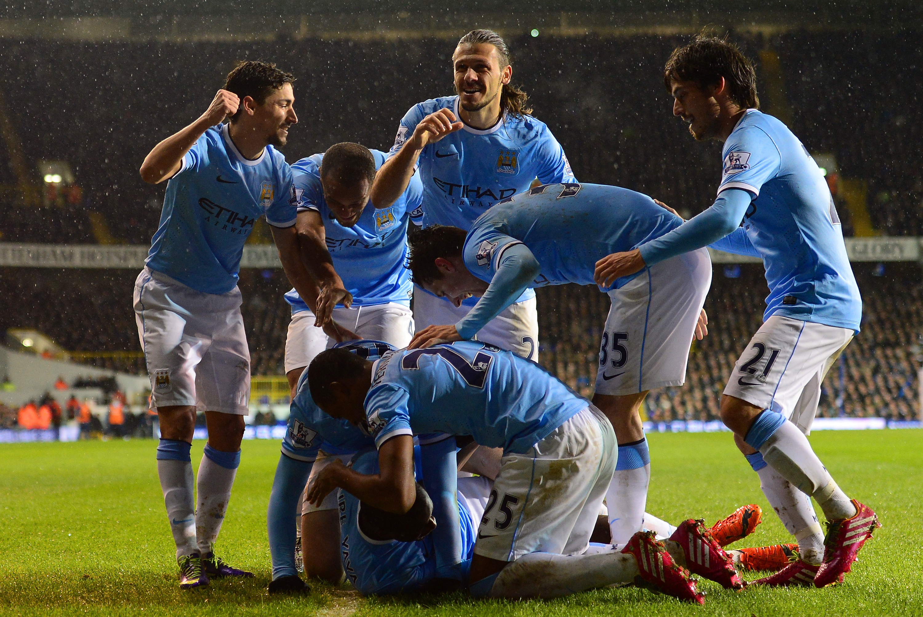 LONDON, ENGLAND - JANUARY 29:  Yaya Toure of Manchester City celebrates scoring their second goal from the penalty spot with his team mates during the Barclays Premier League match between Tottenham Hotspur and Manchester City at White Hart Lane on January 29, 2014 in London, England.  (Photo by Jamie McDonald/Getty Images)