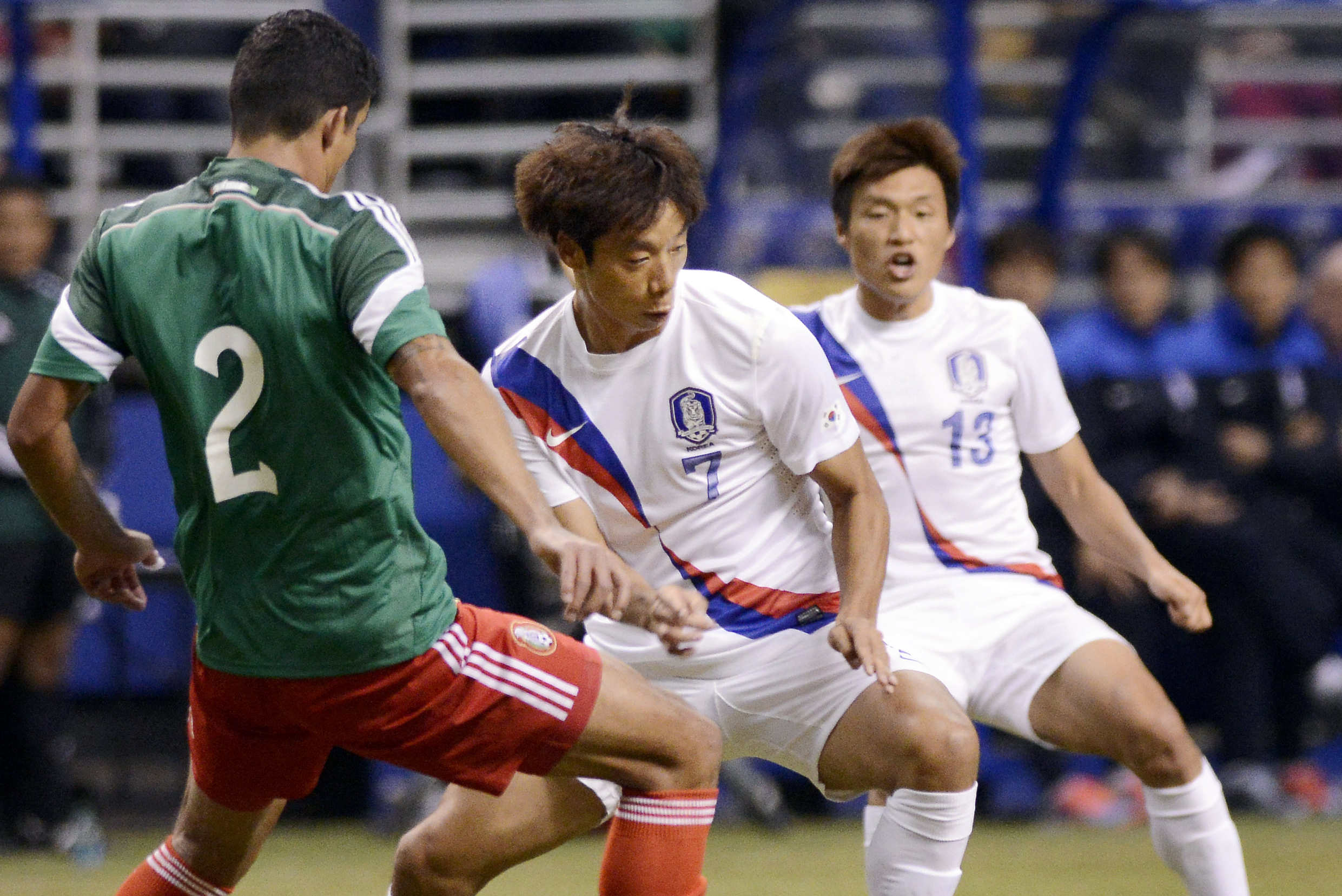 Mexico defender Francisco Javier Rodriguez (2) competes for the ball with South Korea midfielders Yeom Ki-Hun (7) and Lee Myung-Joo during the first half of an international friendly soccer match on Wednesday, Jan. 29, 2014, in San Antonio. (AP Photo/Darren Abate)