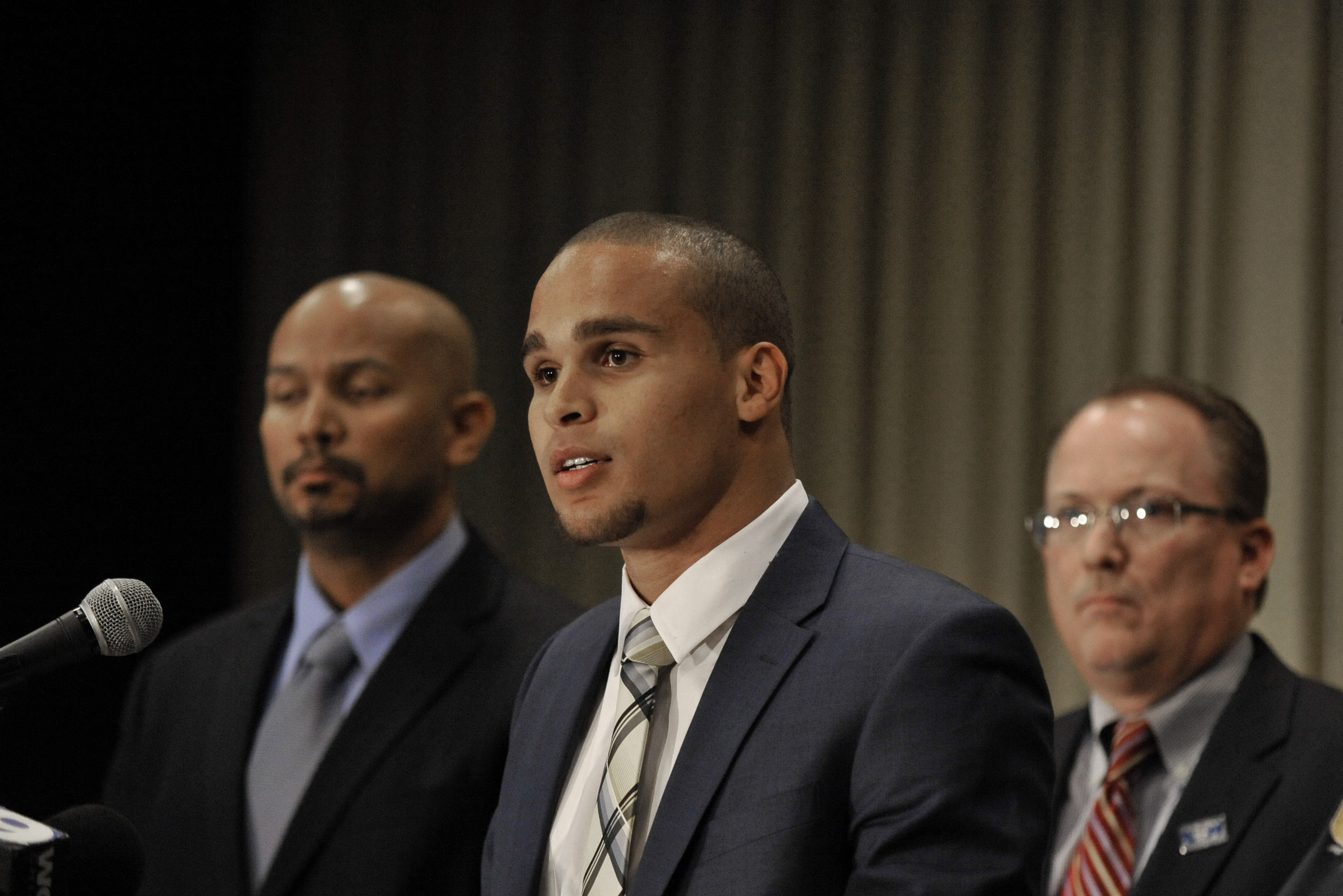 Northwestern quarterback Kain Colter, second from left, speaks while College Athletes Players Association President Ramogi Huma left, United Steelworkers union official Tim Waters, second from right, and Steelworkers President Leo Gerard listen during a news conference in Chicago, Tuesday, Jan., 28, 2014. Football players at Northwestern University are forming what they say is a first-of-its-kind union for college athletes. Wildcat quarterback Kain Coulter joined union leaders at the press conference to announce the creation of the College Athletes Players Association. (AP Photo/Paul Beaty)