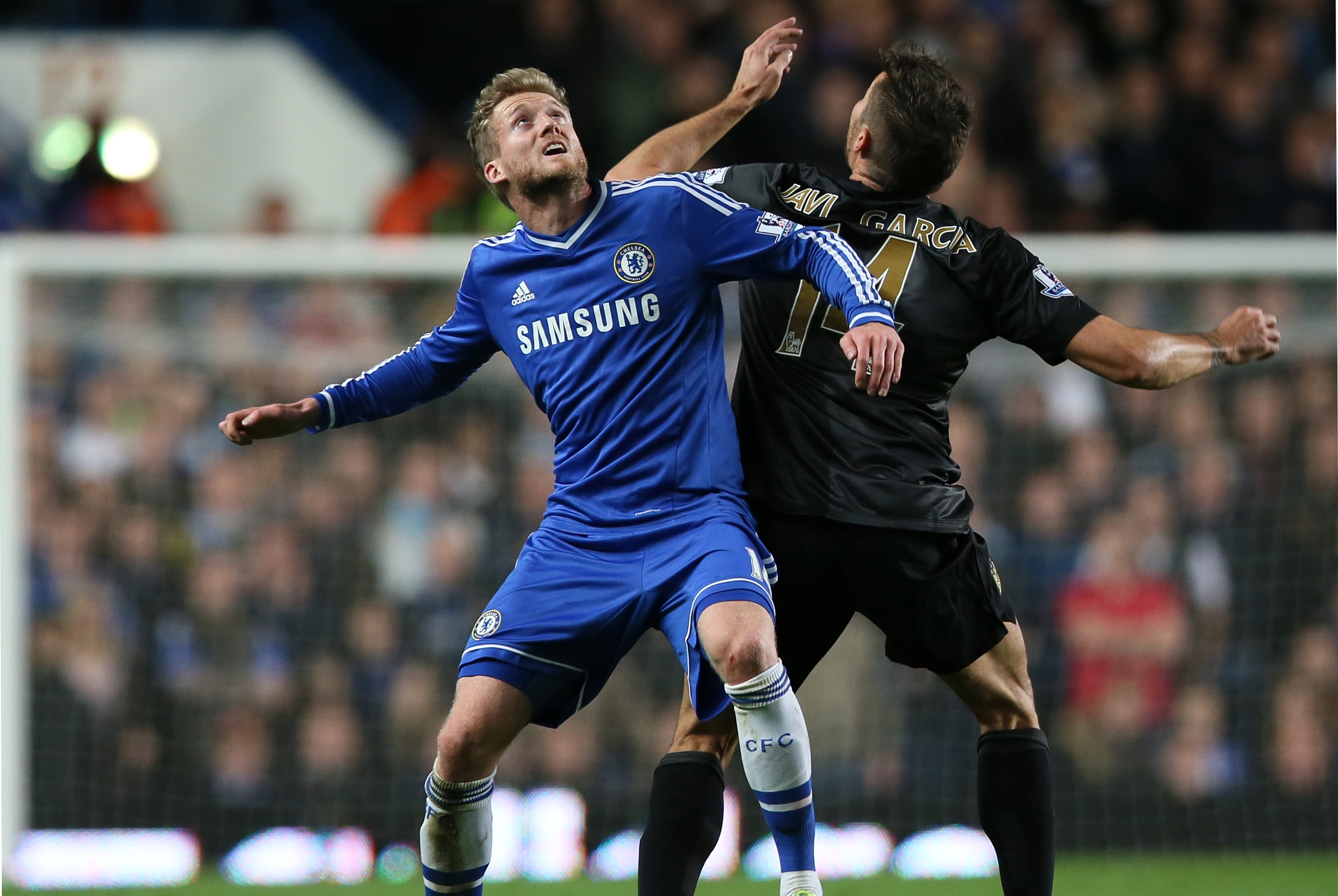 Chelsea's Andre Schuerrle, left, waits for the ball to come down with Manchester City's Javi Garcia during their English Premier League soccer match between Chelsea and Manchester City at Stamford Bridge stadium in London, Sunday, Oct.  27, 2013. (AP Photo/Alastair Grant)