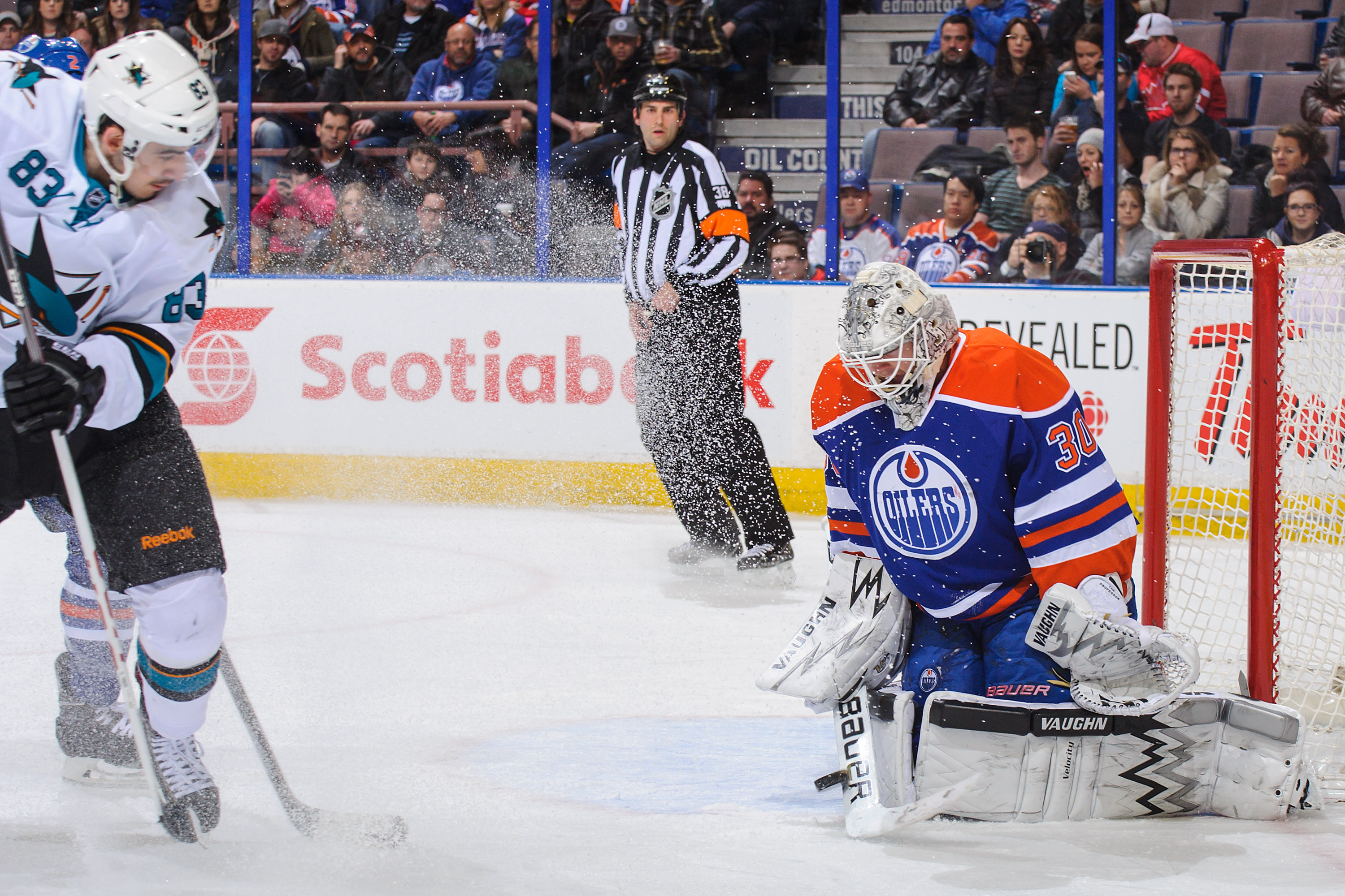 EDMONTON, AB - JANUARY 29: Ben Scrivens #30 of the Edmonton Oilers stops the shot of Matt Nieto #83 of the San Jose Sharks during an NHL game at Rexall Place on January 29, 2014 in Edmonton, Alberta, Canada. (Photo by Derek Leung/Getty Images)
