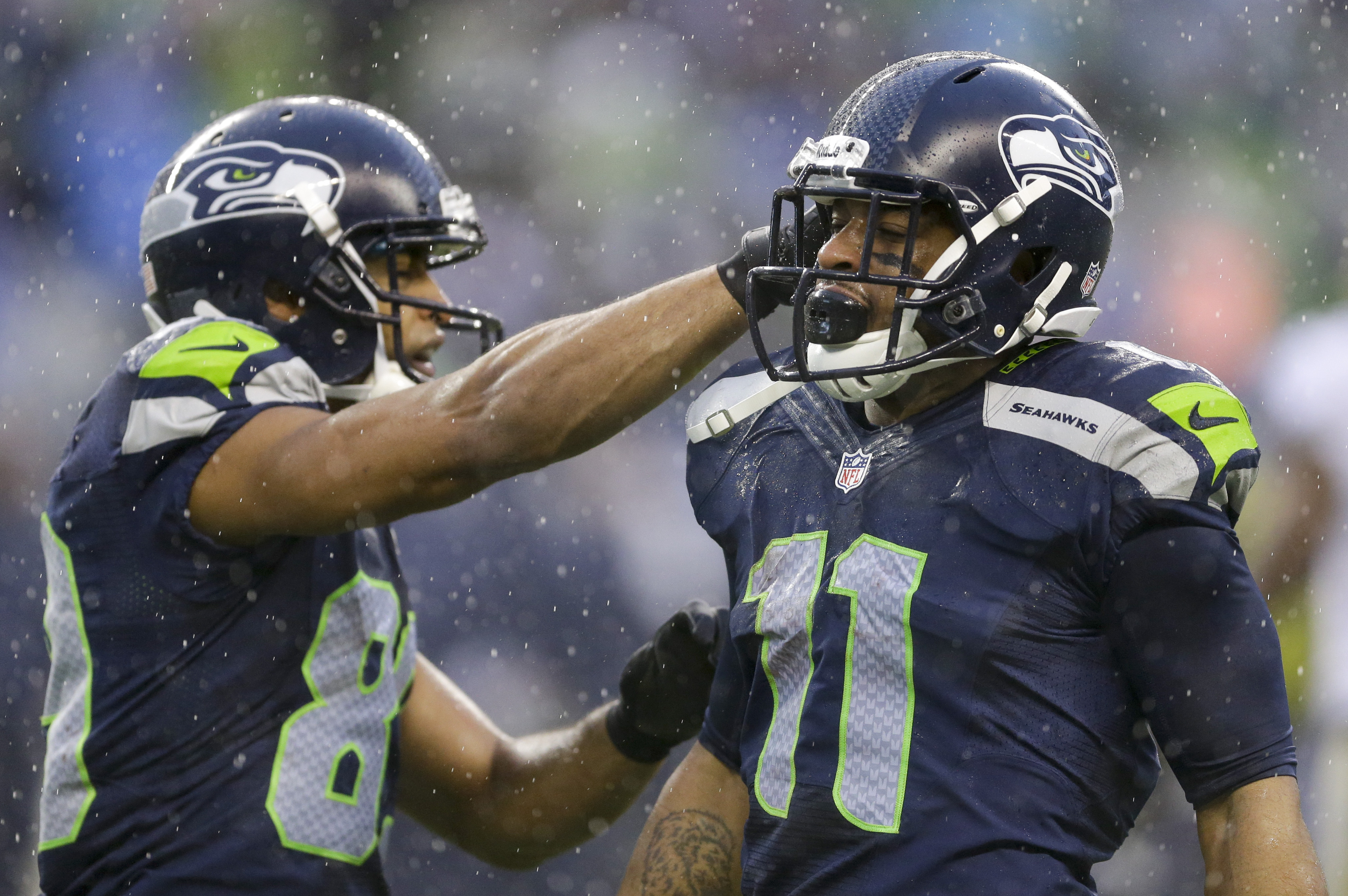 Seattle Seahawks wide receiver Percy Harvin, right, celebrates after catching a pass with wide receiver Doug Baldwin (89) during the second quarter of an NFC divisional playoff NFL football game against the New Orleans Saints in Seattle, Saturday, Jan. 11, 2014. (AP Photo/Ted S. Warren)