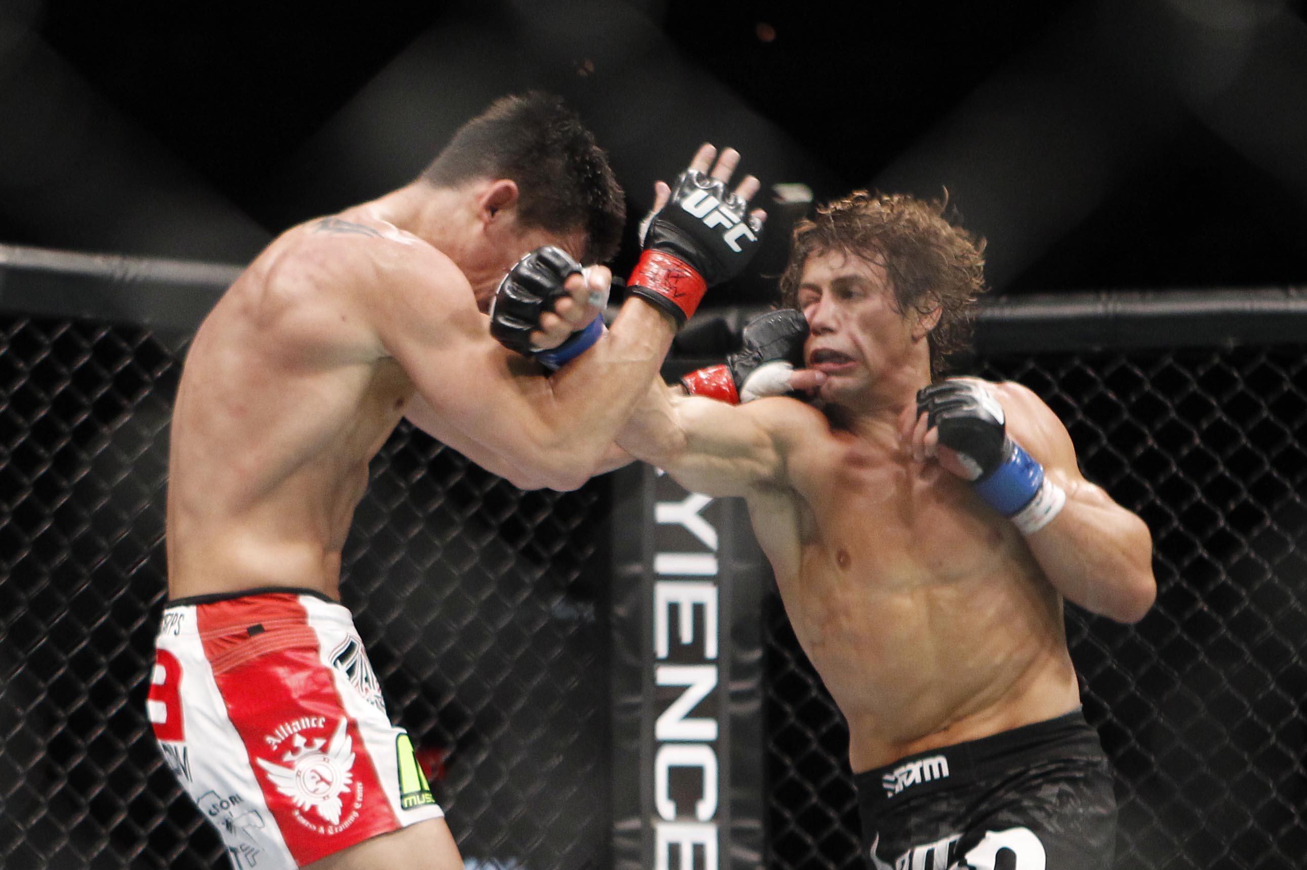 Urijah Faber, right, trades punches with Dominick Cruz during the first round of their UFC bantamweight mixed martial arts title match, Saturday, July 2, 2011 at The MGM Grand Garden Arena in Las Vegas. Cruz won by unanimous decision. (AP Photo/Eric Jamison)