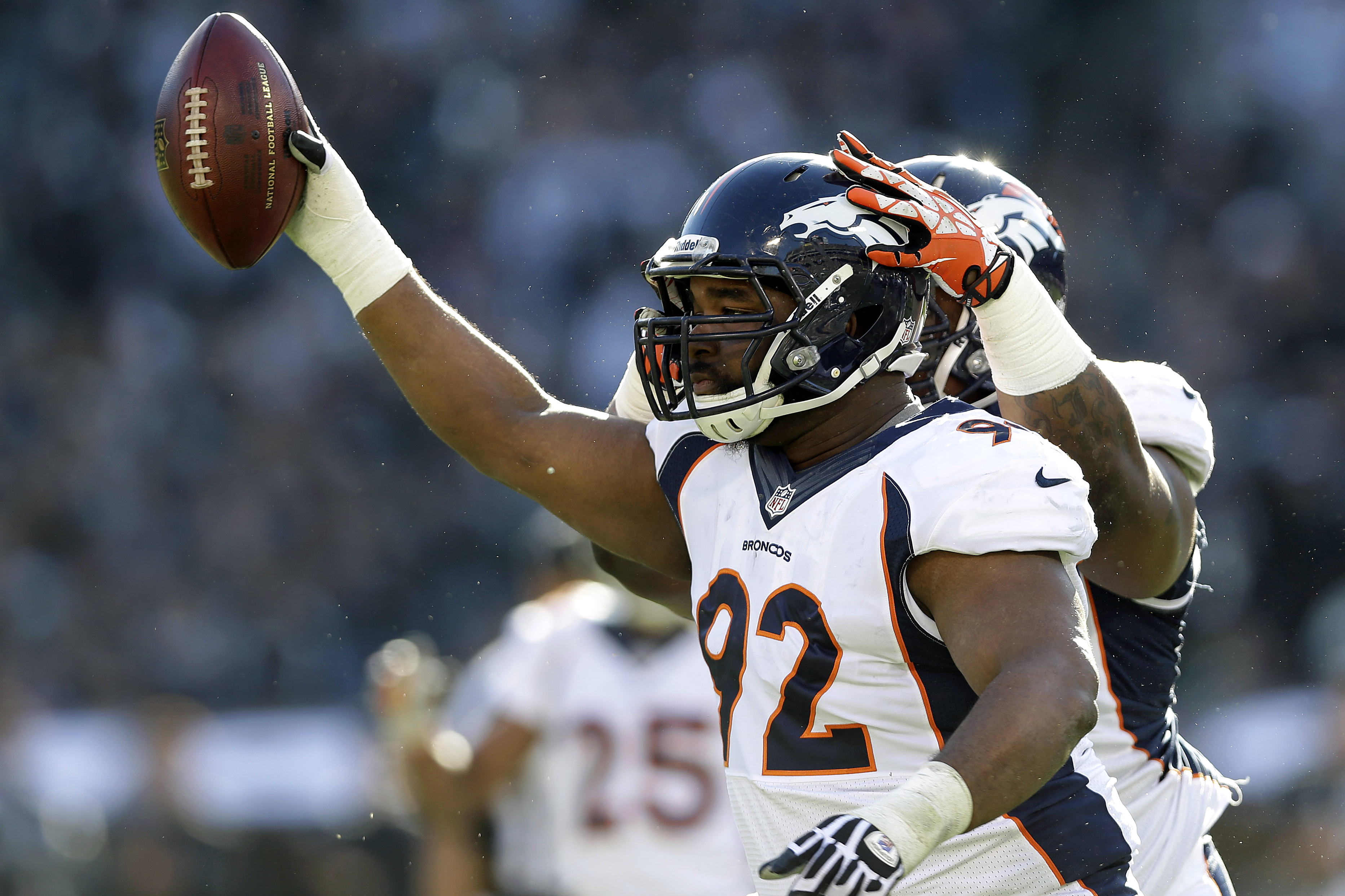Denver Broncos defensive tackle Sylvester Williams (92) celebrates with defensive tackle Terrance Knighton after recovering a fumble by Oakland Raiders quarterback Terrelle Pryor during the first quarter of an NFL football game, Sunday, Dec. 29, 2013, in Oakland, Calif. (AP Photo/Marcio Jose Sanchez)
