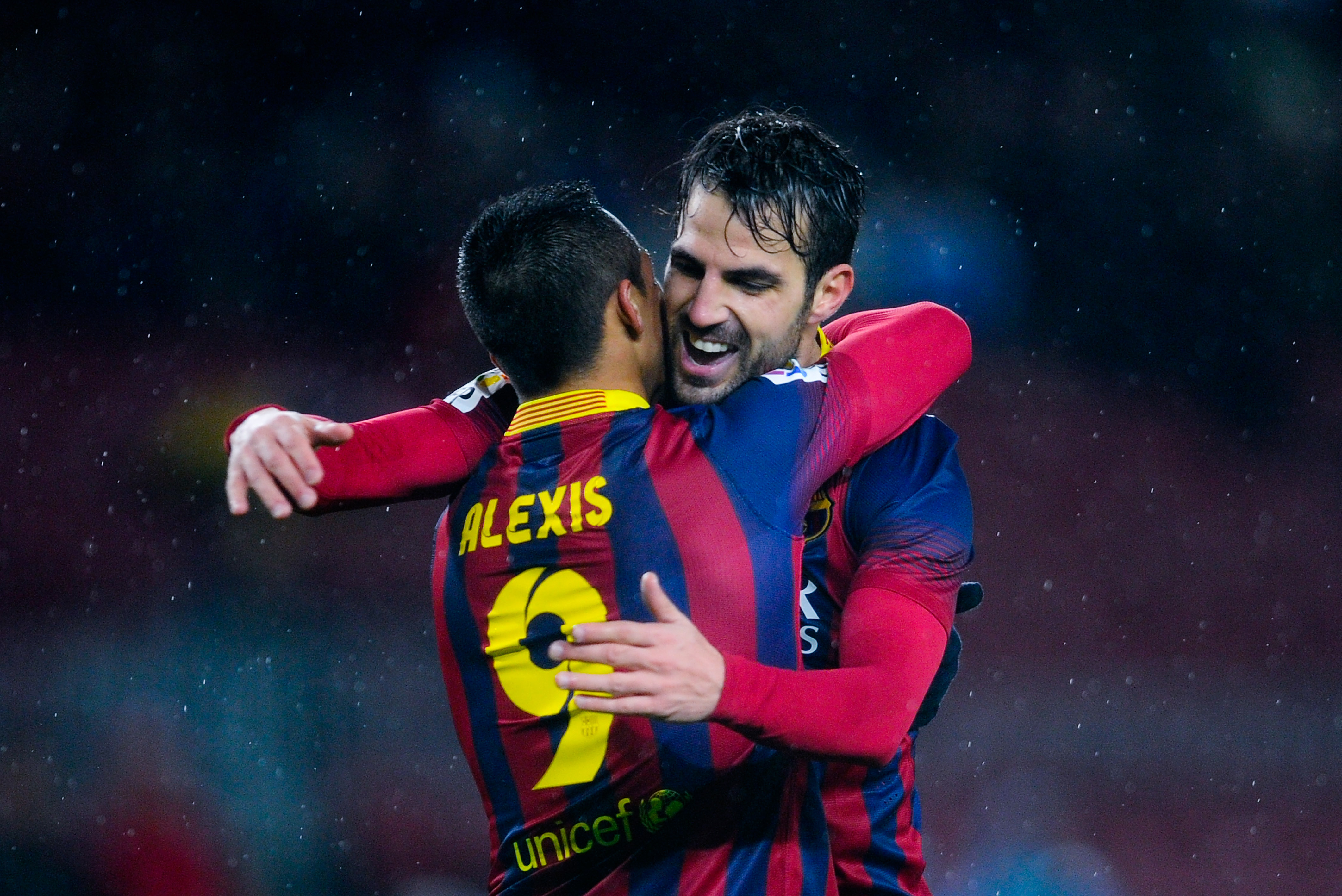 BARCELONA, SPAIN - JANUARY 29:  Cesc Fabregas (R) of FC Barcelona celebrates with his teammate Alexis Sanchez after scoring his team's fifth goal during the Copa del Rey Quarter Final 2nd leg match between FC Barcelona and Levante U.D Camp Nou on January 29, 2014 in Barcelona, Spain.  (Photo by David Ramos/Getty Images)