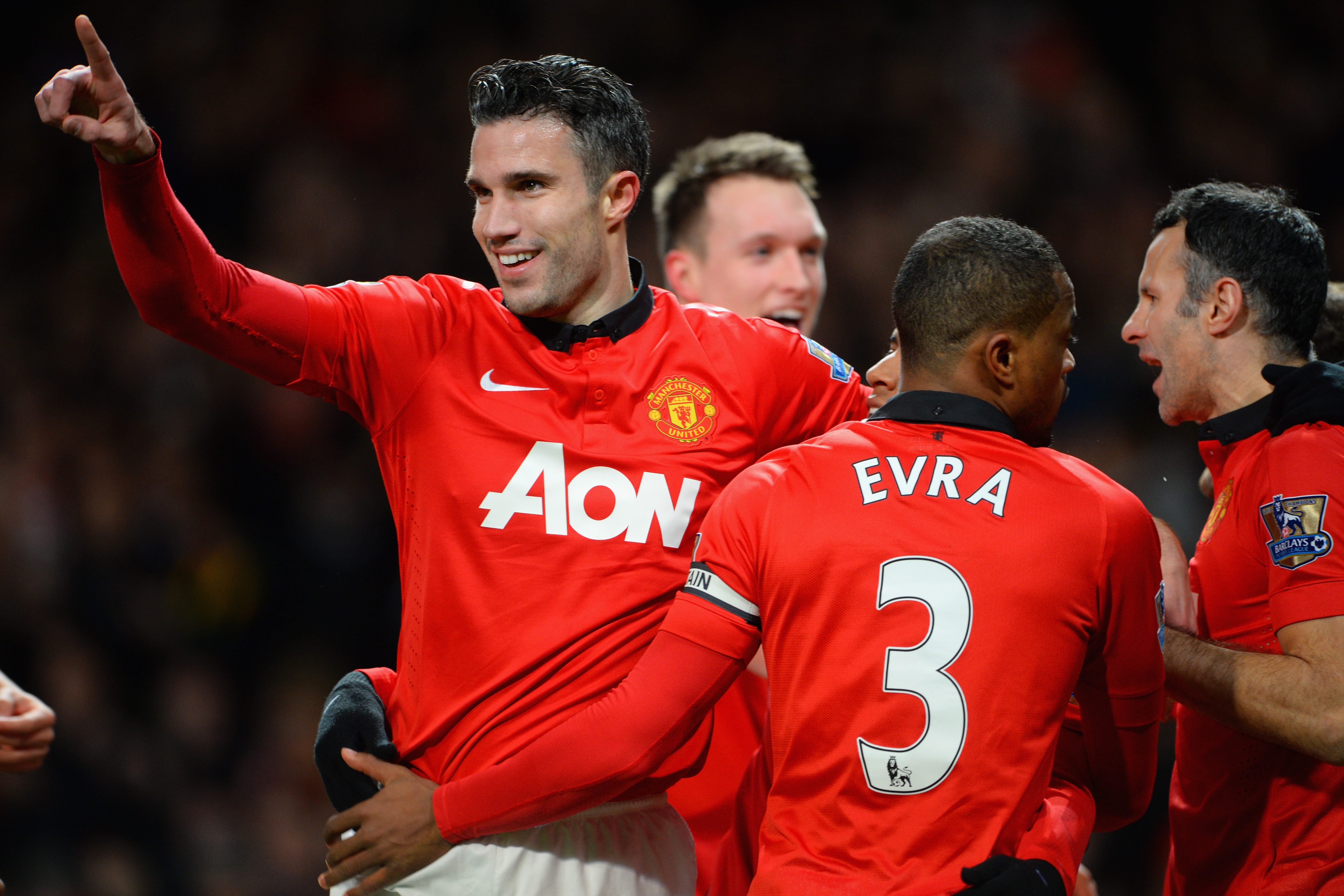 MANCHESTER, ENGLAND - JANUARY 28:  Robin van Persie of Manchester United celebrates scoring the opening goal with his team-mates during the Barclays Premier League match between Manchester United and Cardiff City at Old Trafford on January 28, 2014 in Manchester, England.  (Photo by Michael Regan/Getty Images)