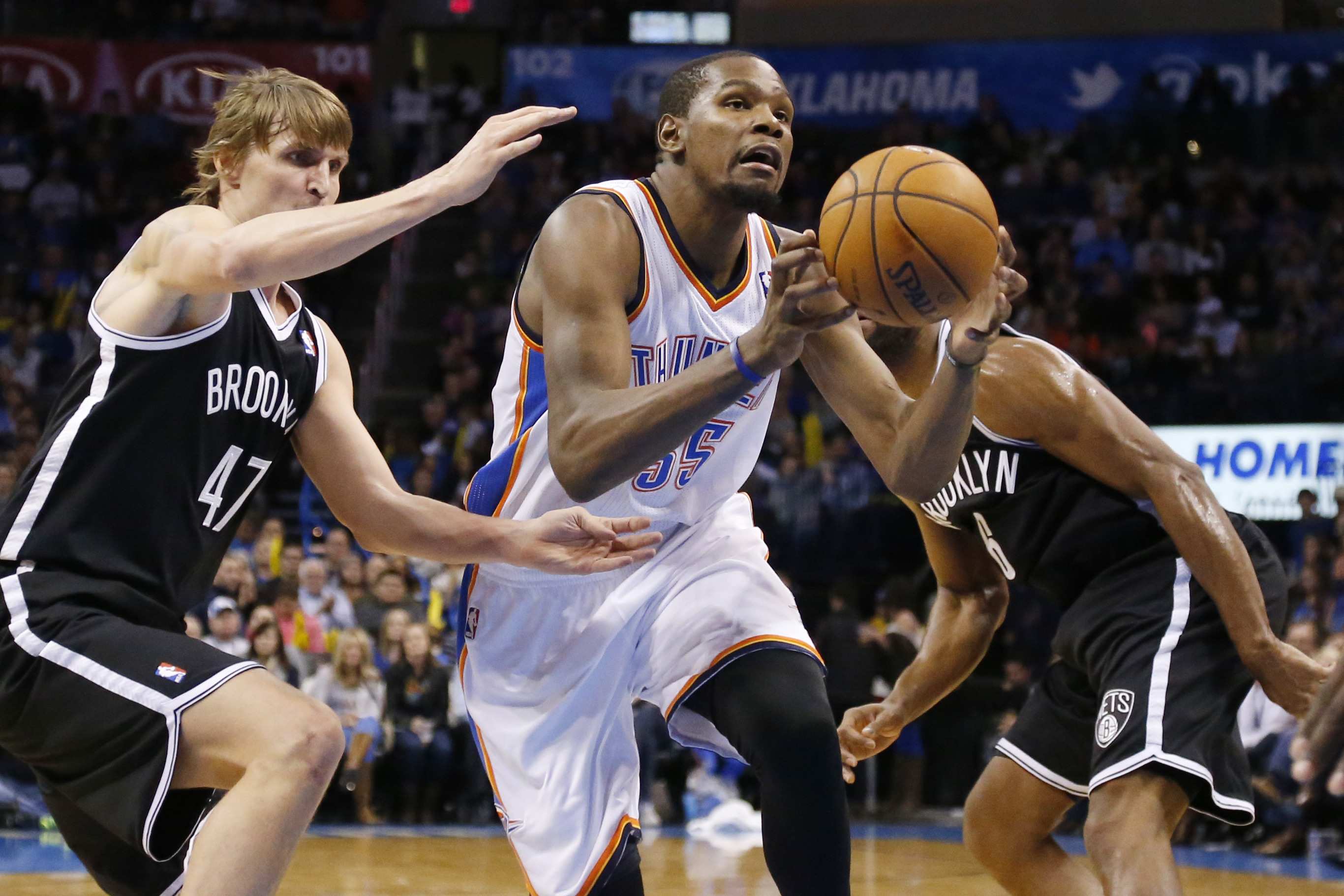 Oklahoma City Thunder forward Kevin Durant (35) drives past Brooklyn Nets forward Andrei Kirilenko (47) and guard Alan Anderson (6) during an NBA basketball game between the Brooklyn Nets and the Oklahoma City Thunder in Oklahoma City, Thursday, Jan. 2, 2014. (AP Photo/Sue Ogrocki)