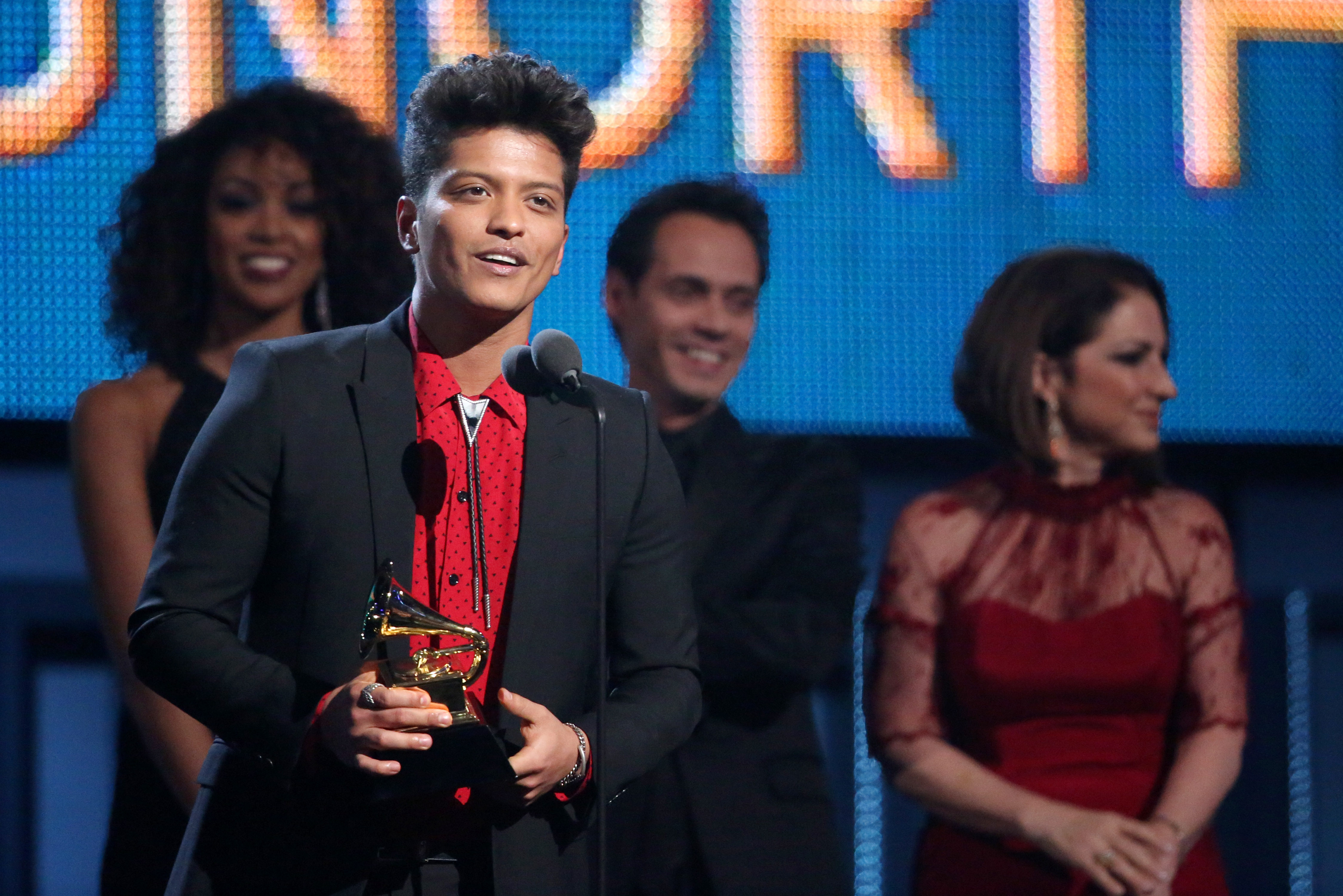Bruno Mars accepts the award for best pop vocal album at the 56th annual GRAMMY Awards at Staples Center on Sunday, Jan. 26, 2014, in Los Angeles. (Photo by Matt Sayles/Invision/AP)