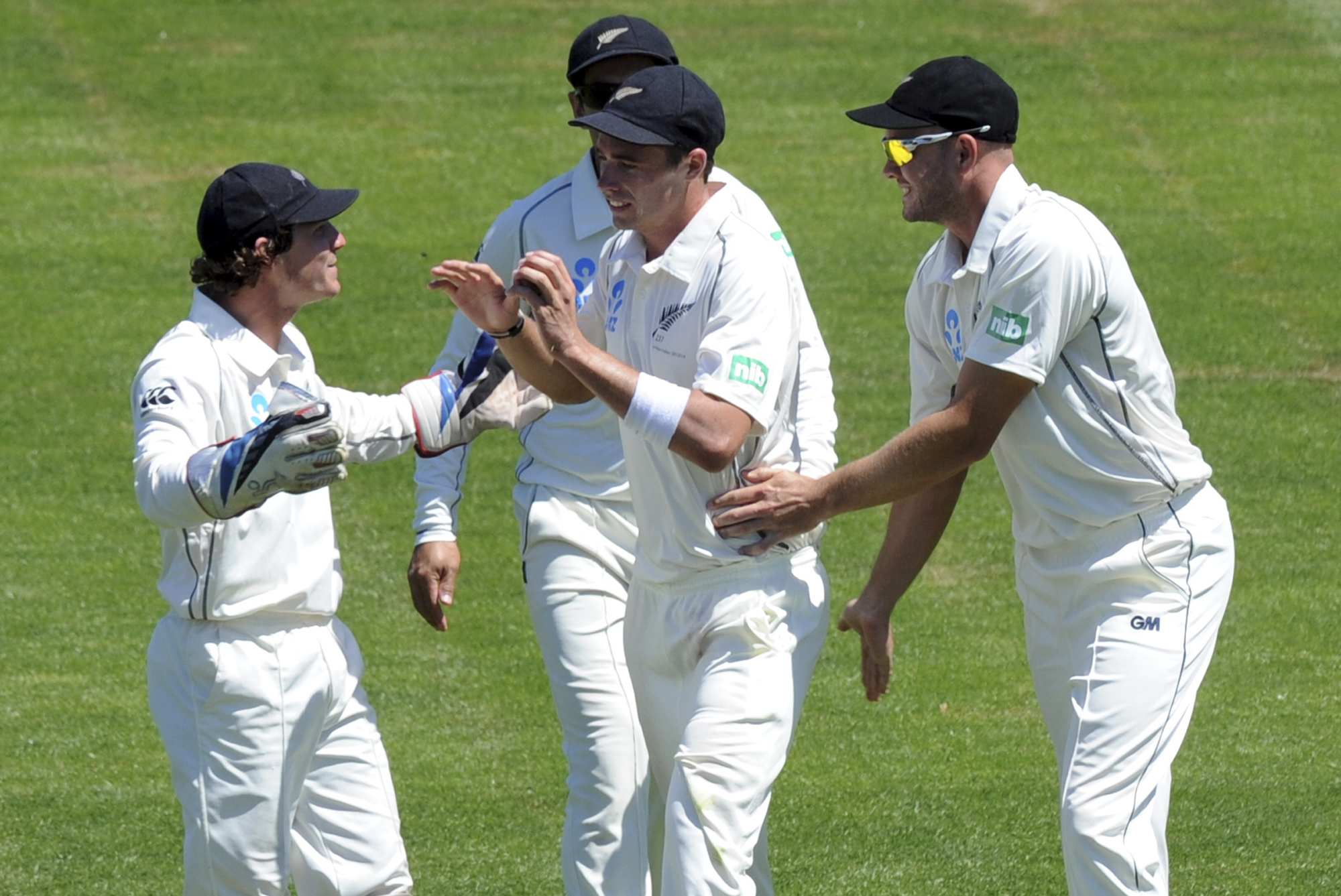 New Zealand's Tim Southee, center, celebrates with B J Watling, left, and Peter Fulton after taking a slip catch to dismiss West Indies Kieron Powell on the third day of their international cricket match in Dunedin, New Zealand, Thursday, Dec. 5, 2013. (AP Photo/SNPA, Ross Setford) NEW ZEALAND OUT