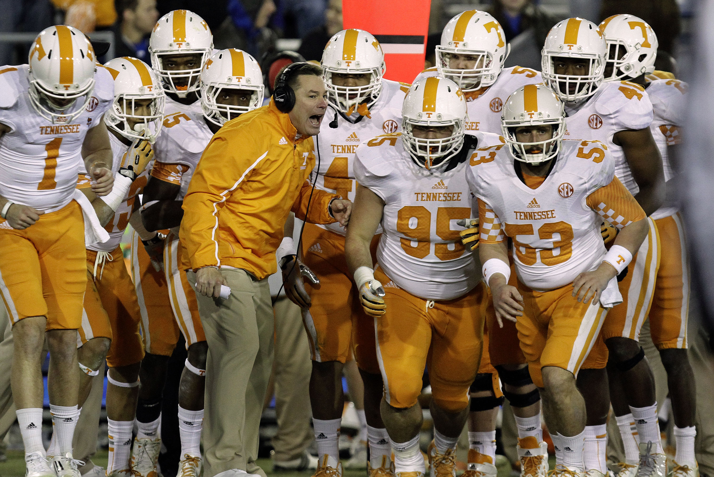 Tennessee coach Butch Jones, center, sends his team ontp the field in the fourth quarter against Kentucky in an NCAA college football game in Lexington, Ky., Saturday, Nov. 30, 2013. Tennessee won 27-14. (AP Photo/Garry Jones)